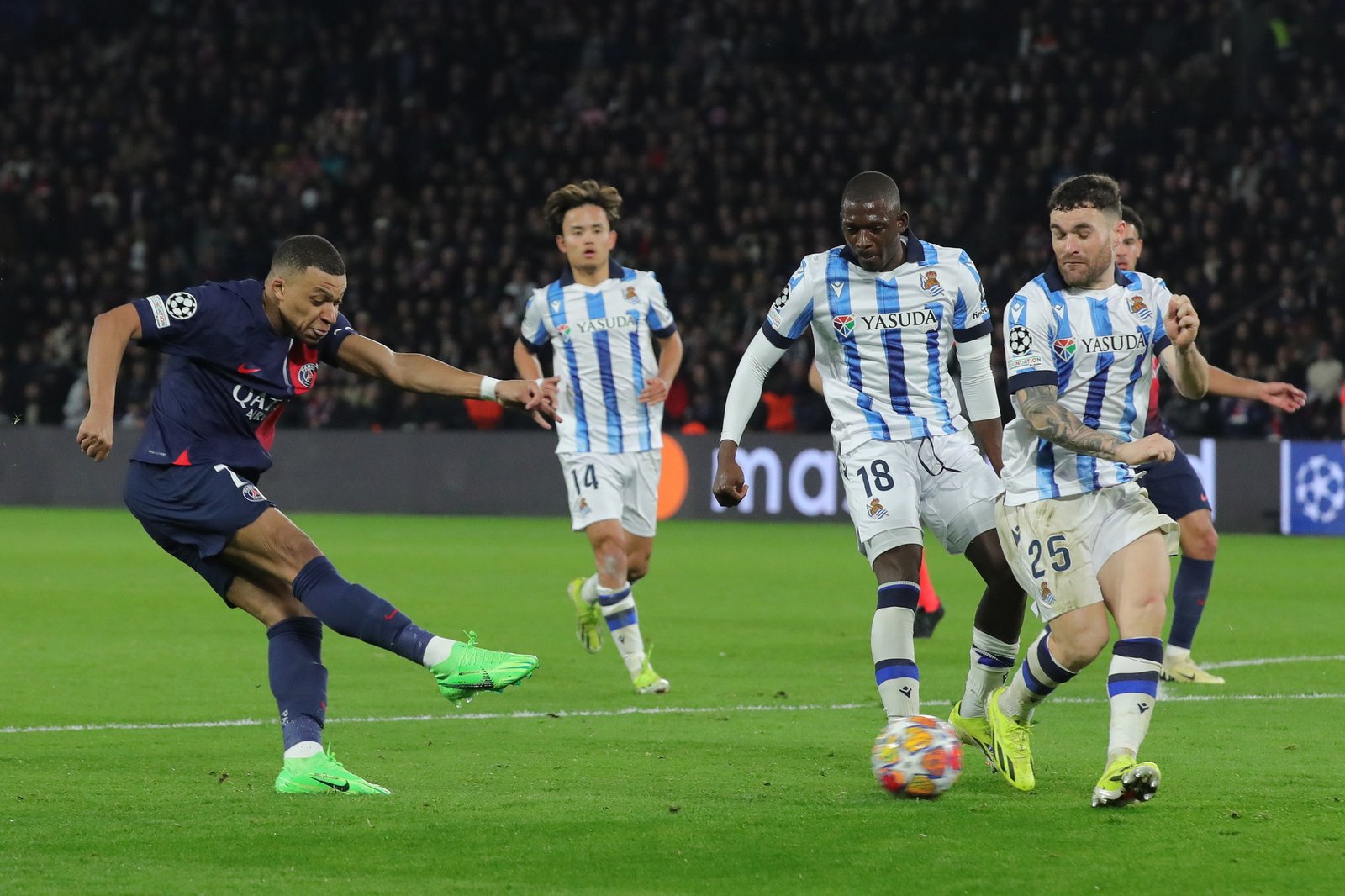 Kylian Mbappe and Javi Galan of Real Sociedad in action